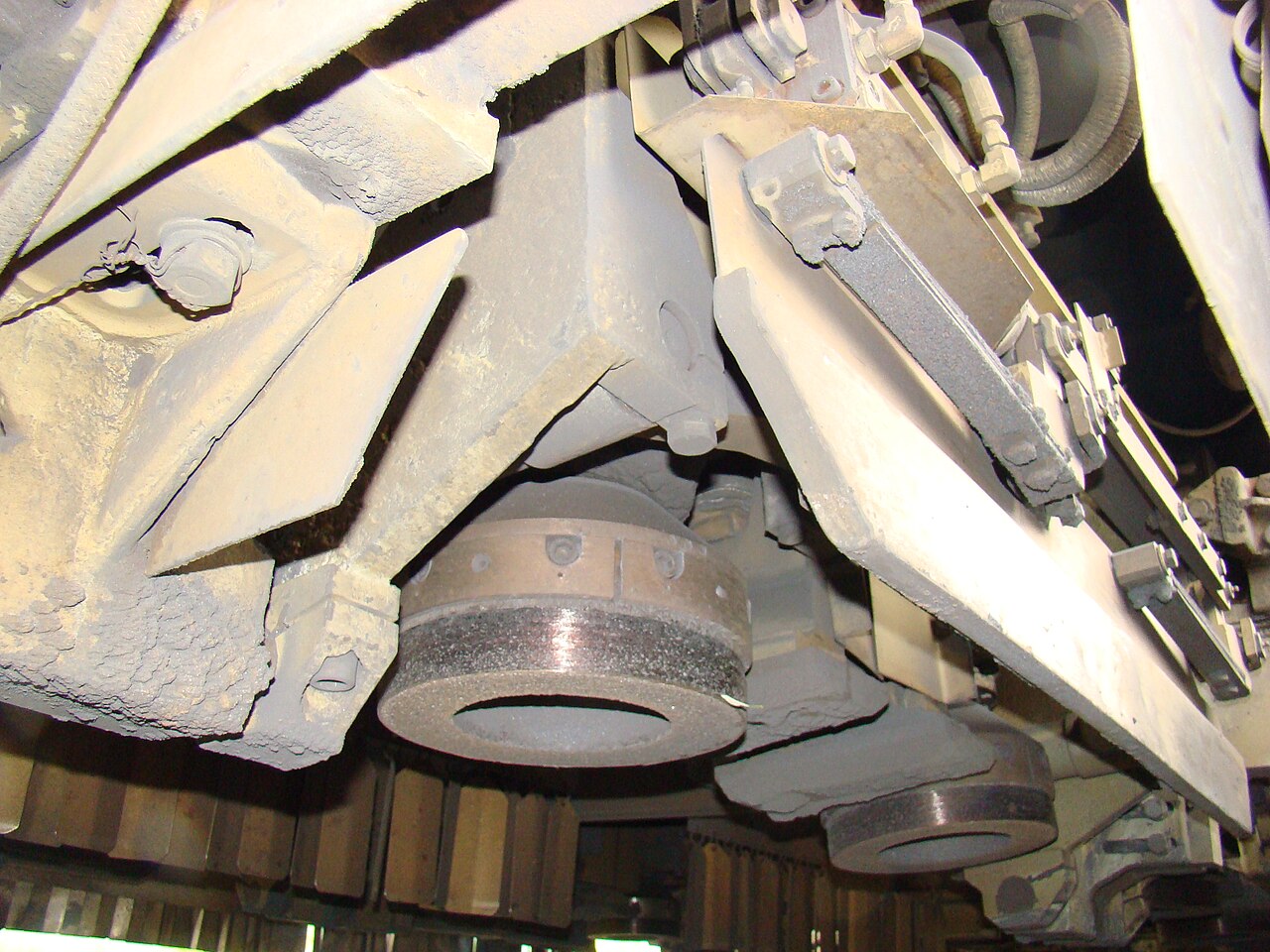 Abrasive grinding wheels mounted under a rail-grinding train